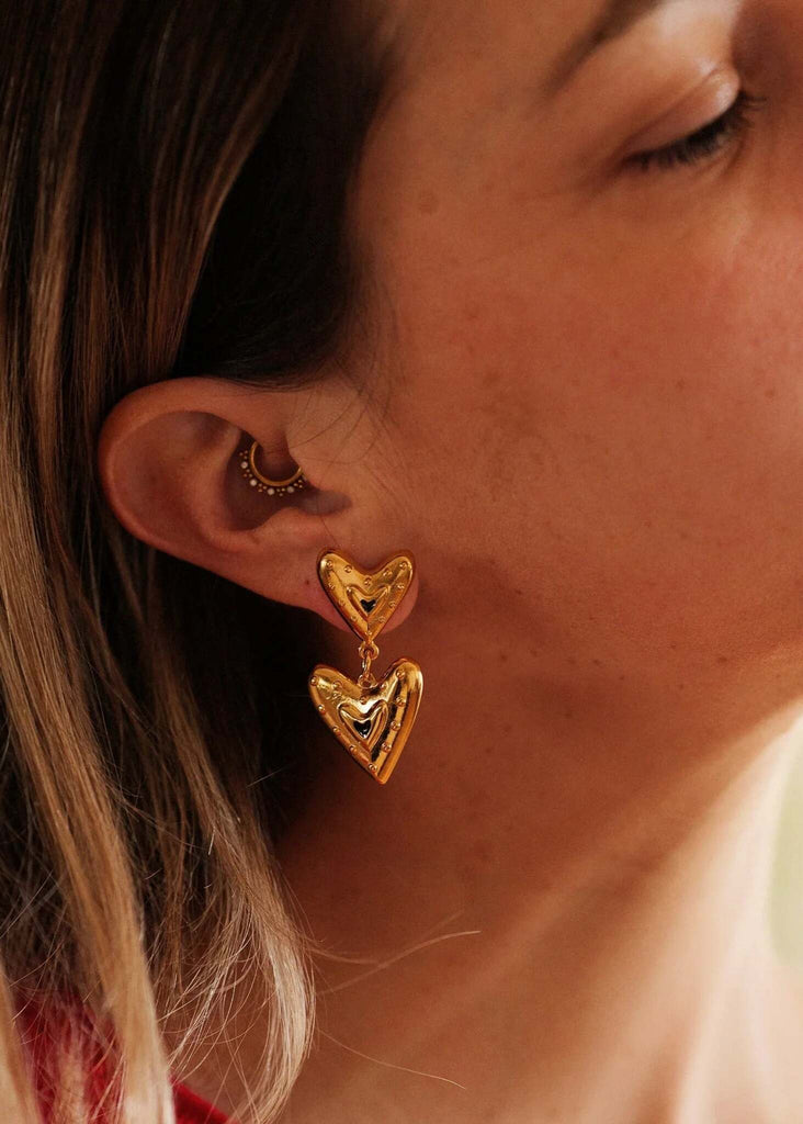Amora Earrings — Gold heart earrings on model, detail — MYFASHIONFRUIT
