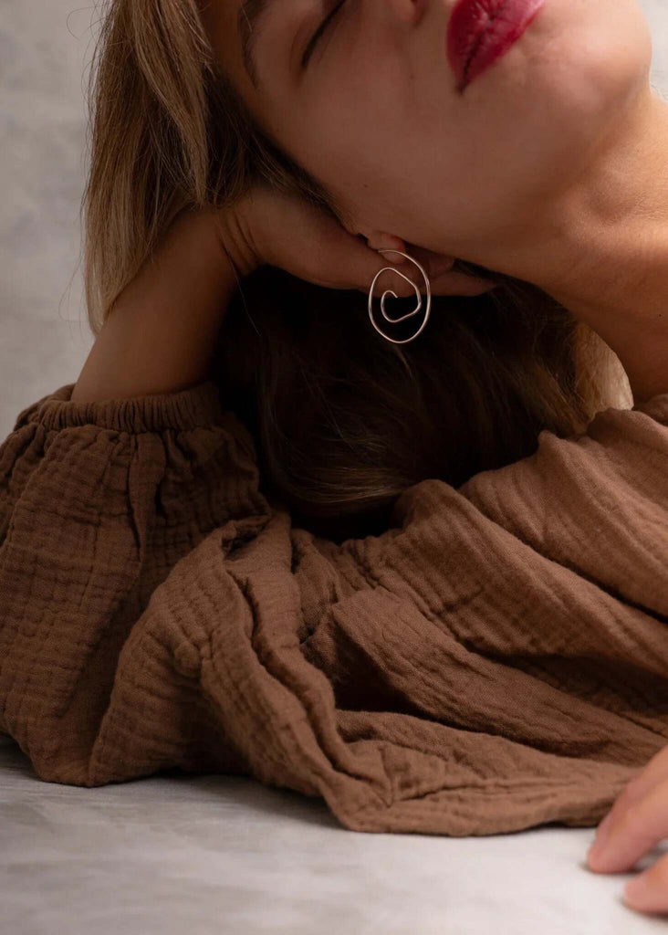 Atalanta Earrings — Gold swirl earring on model — MYFASHIONFRUIT