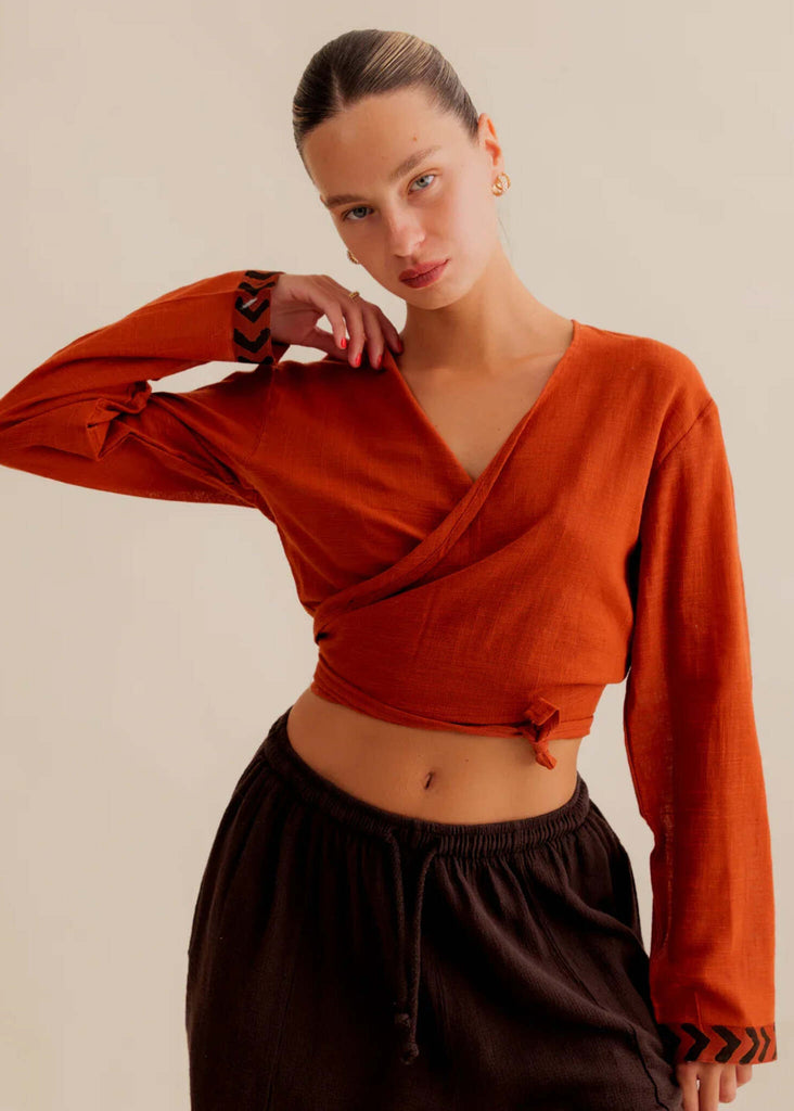 Zoe Wrap Top — Orange wrap top on model with tribal detail on cuffs — MYFASHIONFRUIT