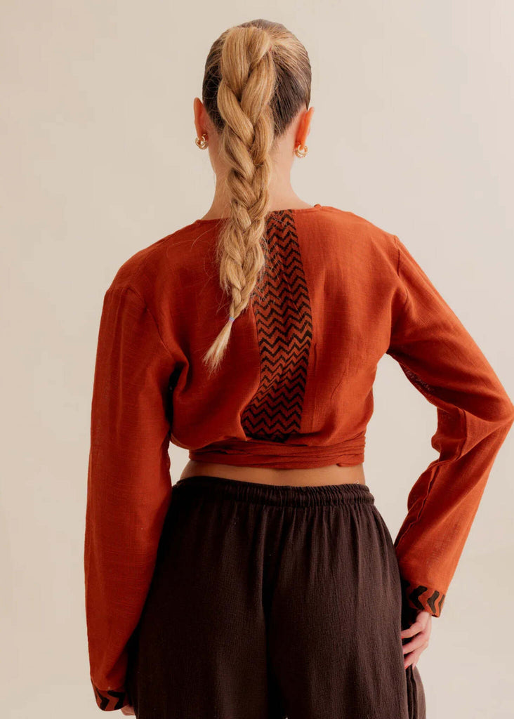 Zoe Wrap Top — Rust-colored wrap top with black detail on model — MYFASHIONFRUIT