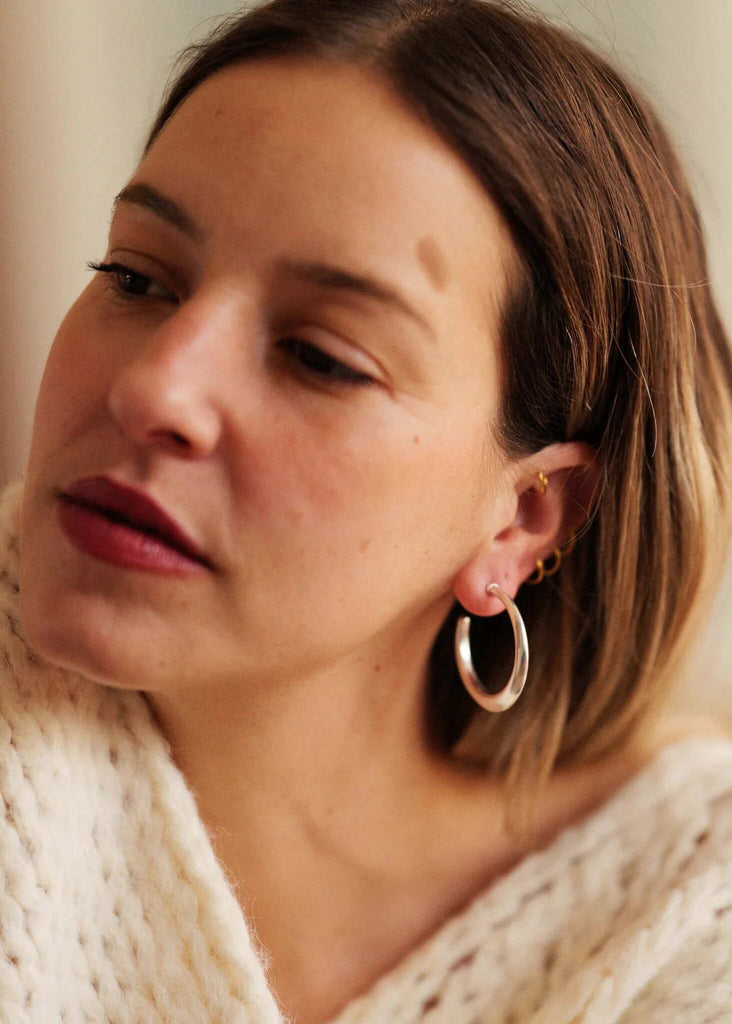 Cay Hoops — Silver hoops on model wearing a sweater — MYFASHIONFRUIT