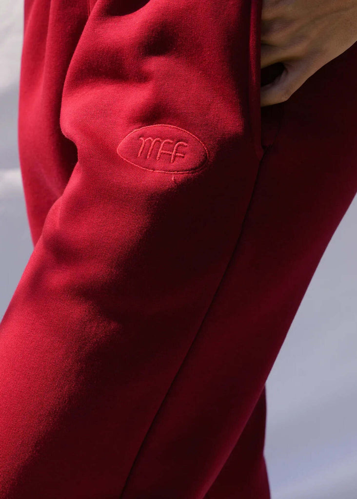 Mff Unisex Sweatpants — Red sweatpants, logo detail, on model — MYFASHIONFRUIT