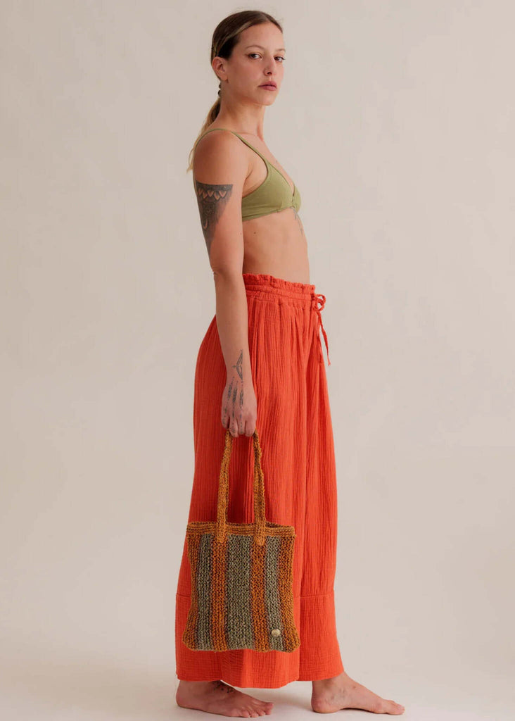 Crochet Striped Bag - Papaya & Green — bag on model with orange pants — MYFASHIONFRUIT