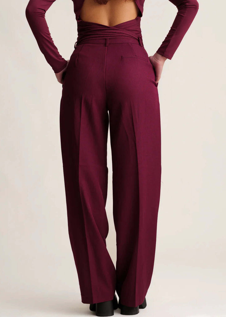 Michelle Trousers — Wide leg burgundy trousers on model, back view — MYFASHIONFRUIT