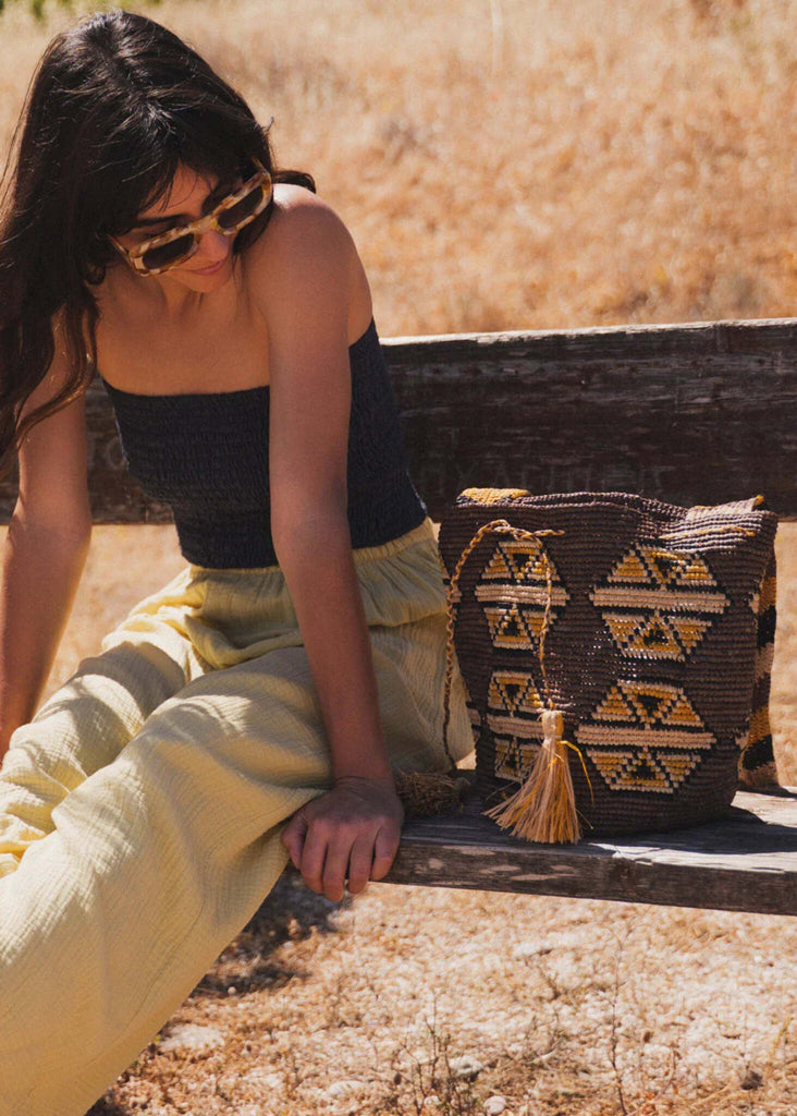 Koo Bucket Bag — woven bag with tassel on model — MYFASHIONFRUIT