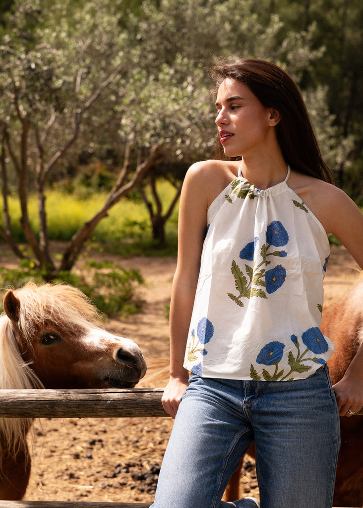 Sajani Top — White halter top with blue flower print on model — MYFASHIONFRUIT