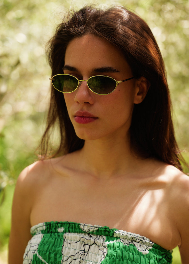 Komono TYLA Sunglasses — model wearing gold sunglasses, green top — MYFASHIONFRUIT