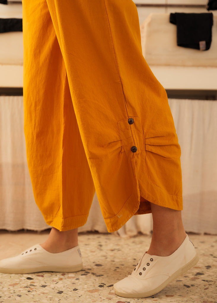 Mayaa Dungarees — Detail of mustard pants with buttons on model — MYFASHIONFRUIT