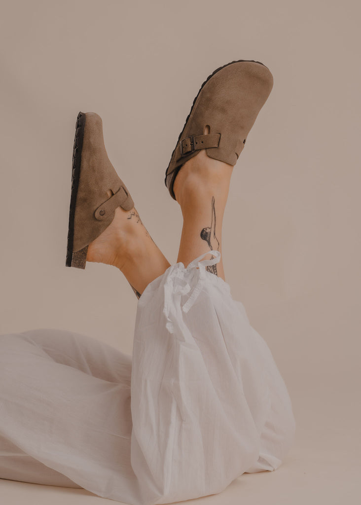 Bilbao Suede Clogs — Taupe suede clogs on model wearing white fabric — MYFASHIONFRUIT