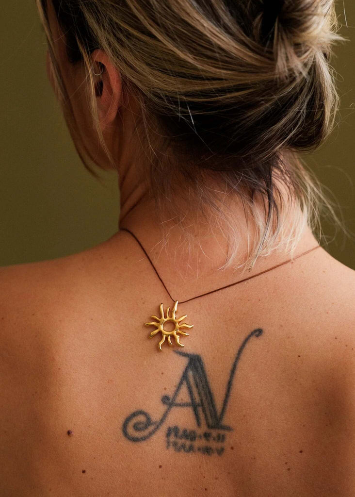 Sandya Pendant — Gold sun pendant on model, close-up — MYFASHIONFRUIT