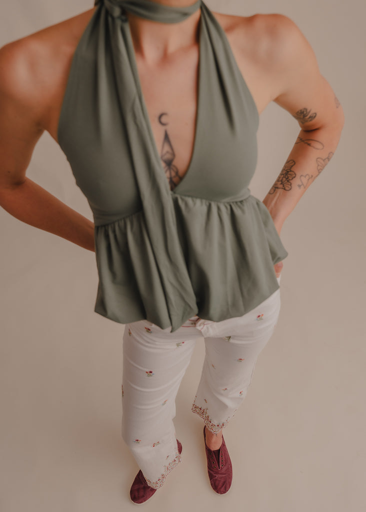 Green halter top and white floral pants on model — MYFASHIONFRUIT