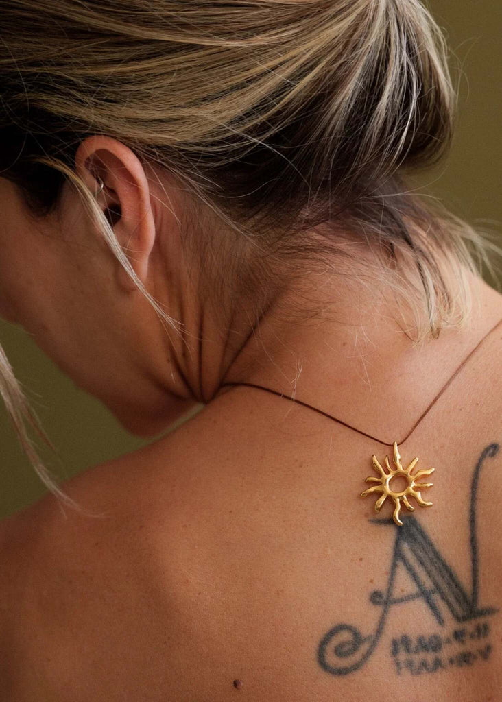 Sandya Pendant — Gold sun pendant on model, detail — MYFASHIONFRUIT