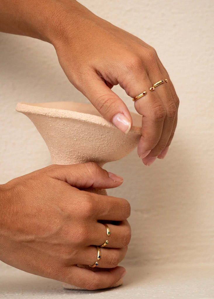Dione Ring — Gold rings on model holding vase — MYFASHIONFRUIT