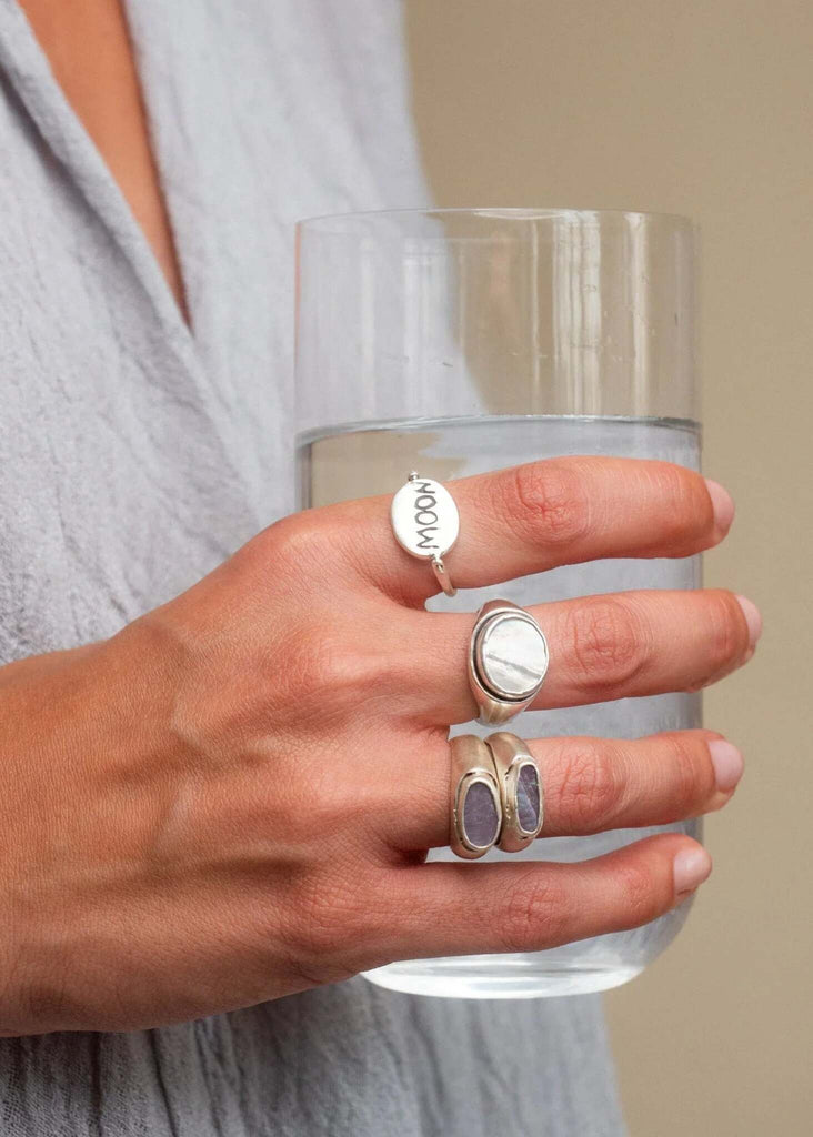 Amalthea Ring — silver rings detail on hand holding glass — MYFASHIONFRUIT