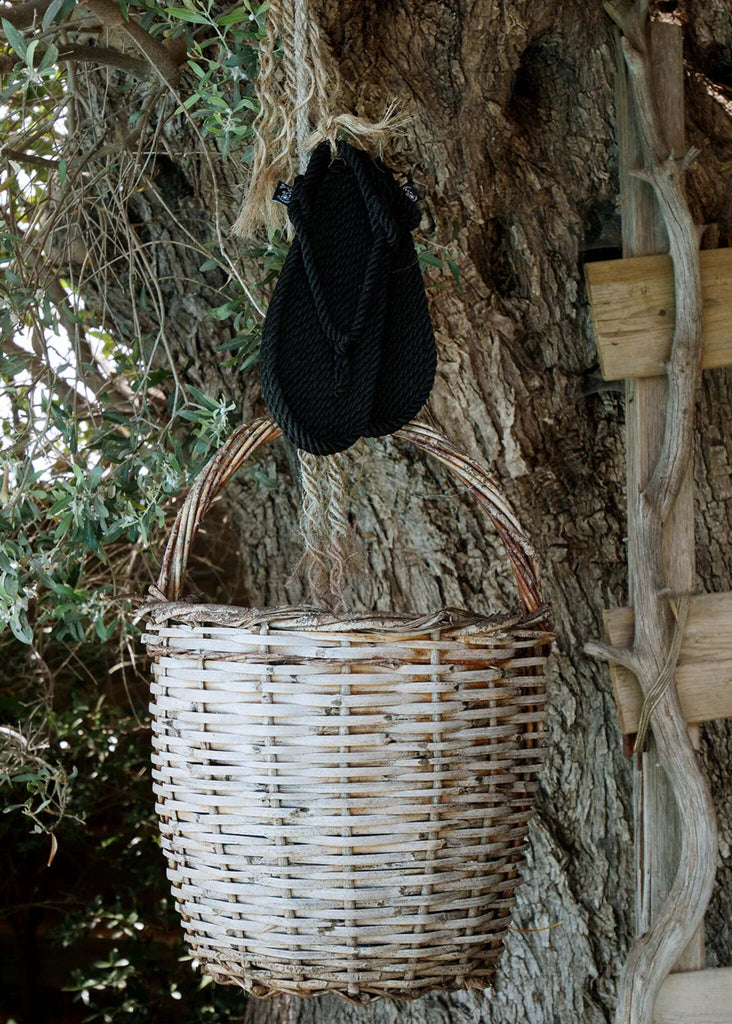 Flop Black Sandals — Sandals hanging above woven basket — MYFASHIONFRUIT