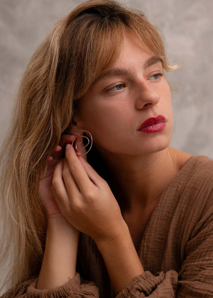 Woman wearing silver Atalanta Earrings with a spiral design — MYFASHIONFRUIT