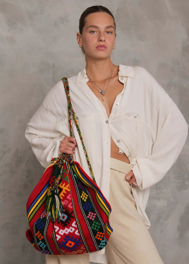 Woman wearing a Roxane Handloom Bag, red with multicolor woven detail — MYFASHIONFRUIT