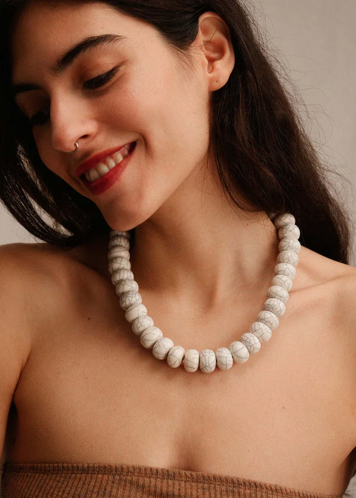 Woman wearing the Sahara Necklace — white marble bead necklace — MYFASHIONFRUIT