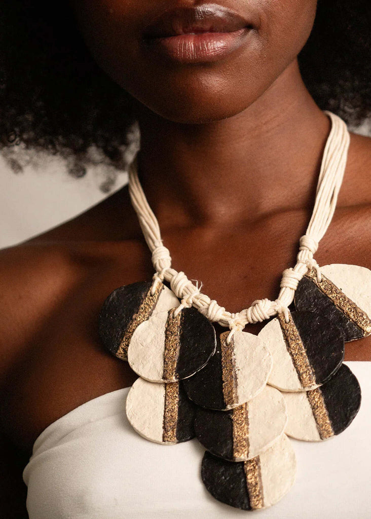 Woman wearing Ceres Necklace — black and off-white paper mache pendants with gold detail — MYFASHIONFRUIT