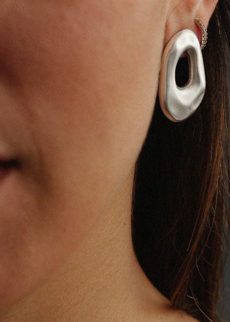 Woman wearing Raw Earrings — silver tone, oval design — MYFASHIONFRUIT