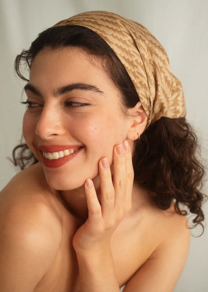 Woman wearing a beige printed silk scarf as a head covering — MYFASHIONFRUIT