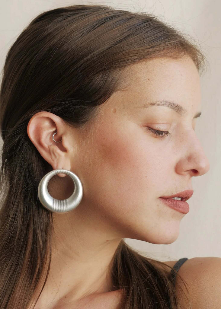 Woman wearing Aziza Hoops — large silver hoops with engraved detail — MYFASHIONFRUIT