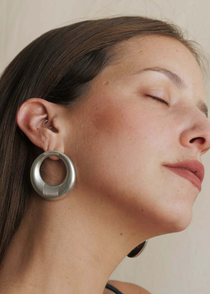 Woman wearing Aziza Hoops — silver earrings with engraved detail — MYFASHIONFRUIT