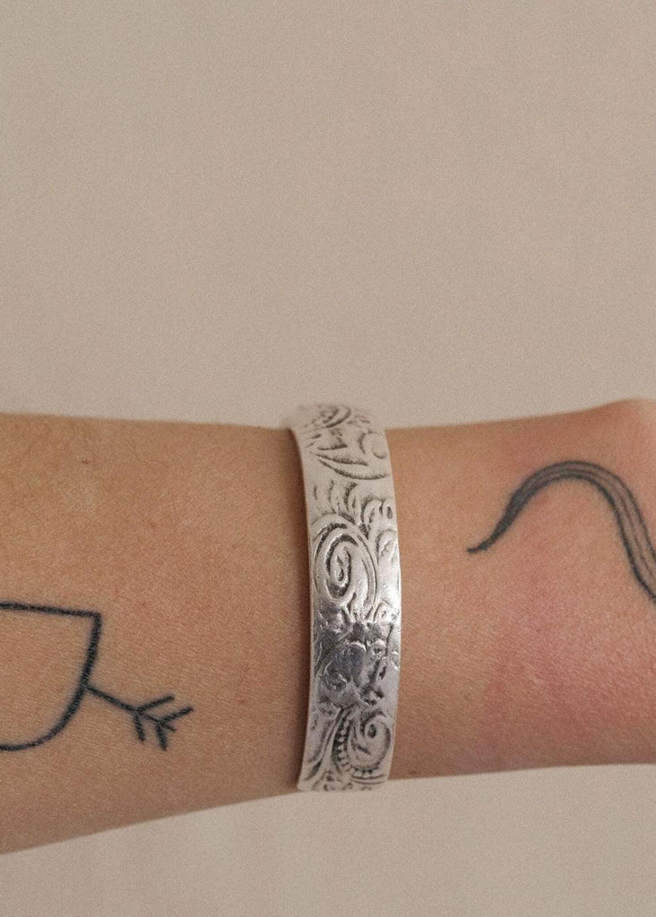 Treasure Cuff — silver, floral pattern detail on model — MYFASHIONFRUIT