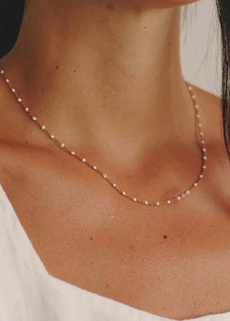 Dakota Necklace — gold chain with small white enamel beads on model — MYFASHIONFRUIT