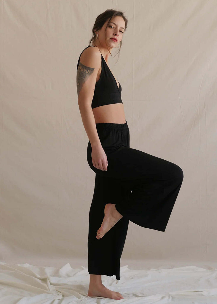 Woman wearing black Tender Pants loungewear set with bralette and wide leg pants — MYFASHIONFRUIT