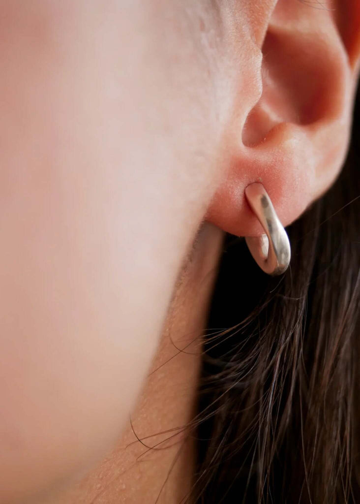 Hebe Hoops — silver hoop earring detail on model's ear — MYFASHIONFRUIT