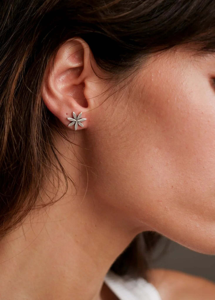 Woman wearing Anthea Earrings — silver flower design ear studs — MYFASHIONFRUIT