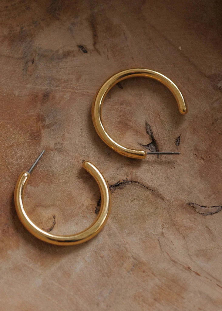 Susie Hoops — Gold, close-up on wood — MYFASHIONFRUIT