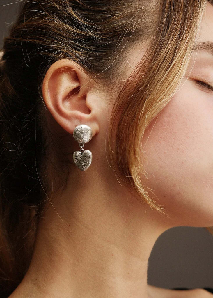 Woman wearing silver tone Esme Earrings with fingerprint pattern — MYFASHIONFRUIT