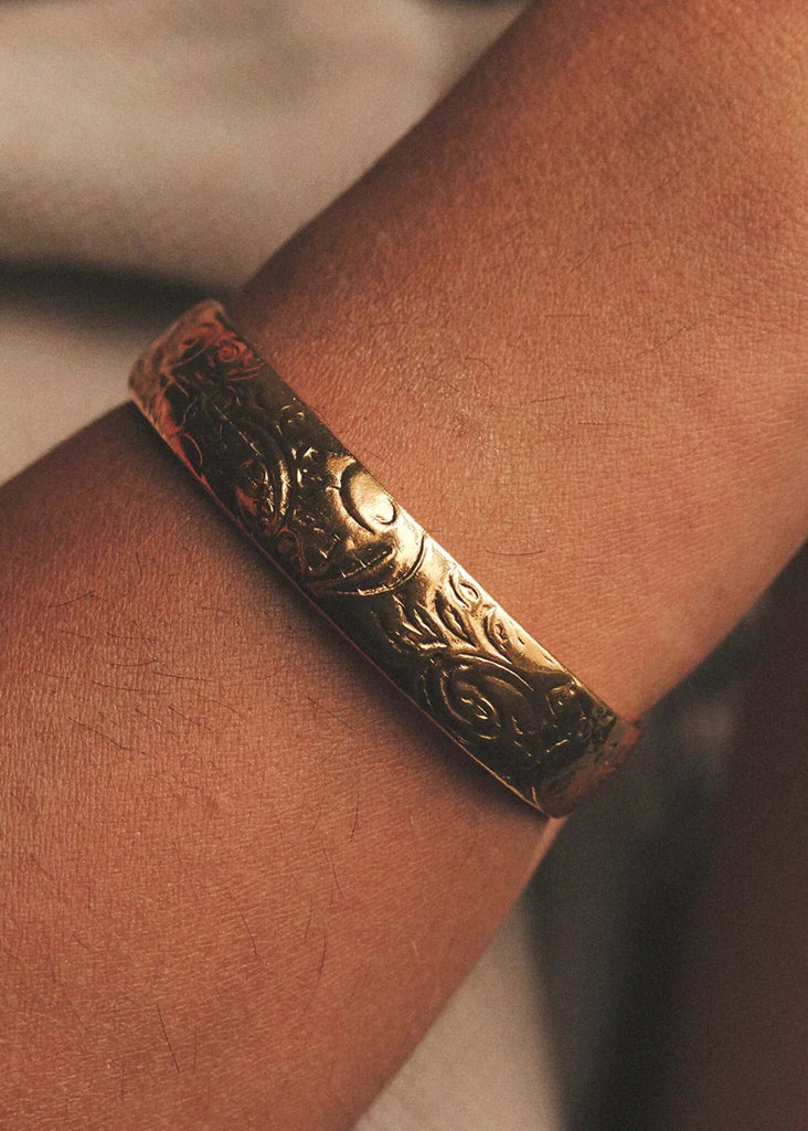 Treasure Cuff detail — gold carved bangle on a wrist — MYFASHIONFRUIT