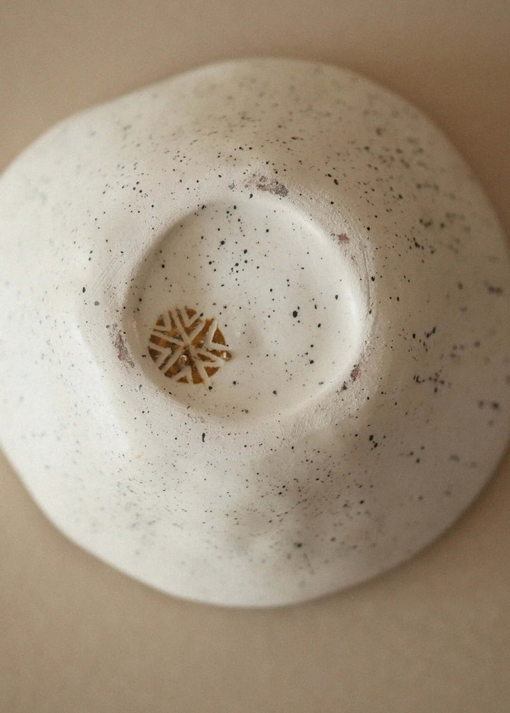 Gaia Tribal Bowl — speckled white ceramic, detail of mustard tribal symbol at base — MYFASHIONFRUIT