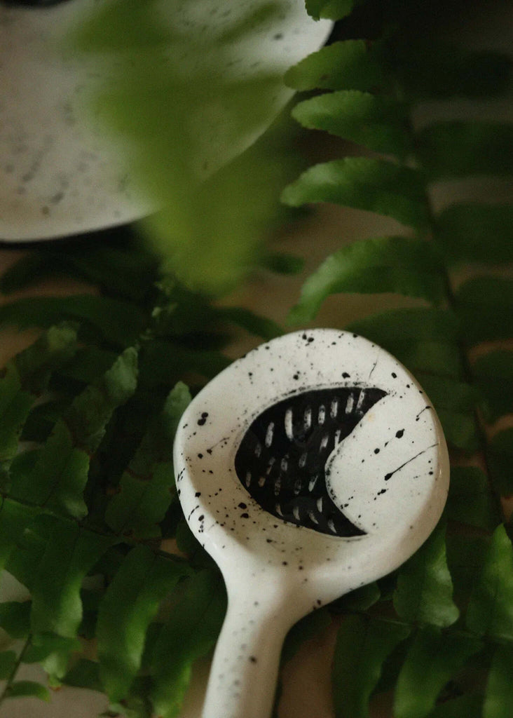 The Moon Spoon — white ceramic with black moon detail, splatter pattern — MYFASHIONFRUIT
