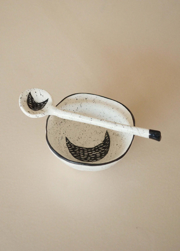 The Moon Spoon flat lay — white ceramic with black moon detail — MYFASHIONFRUIT
