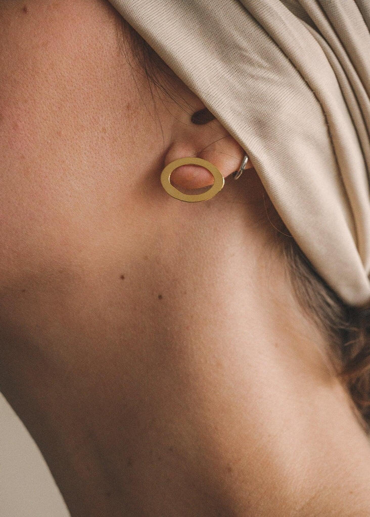 Woman wearing Ciclo Golden Earrings — gold oval shape — MYFASHIONFRUIT