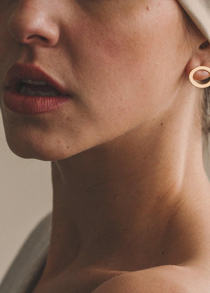 Ciclo Golden Earrings — gold oval stud on model — MYFASHIONFRUIT